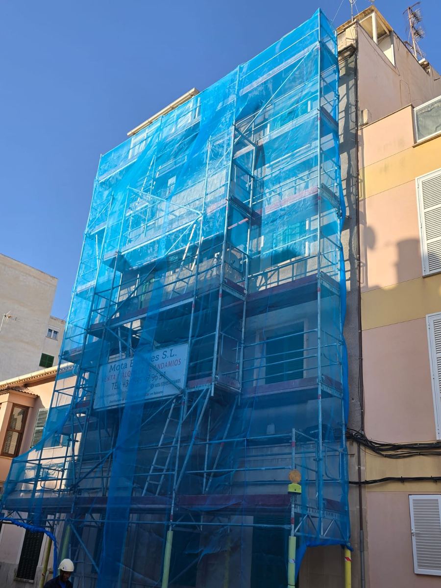 Edificio con red azul y cartel de Mota Esteves